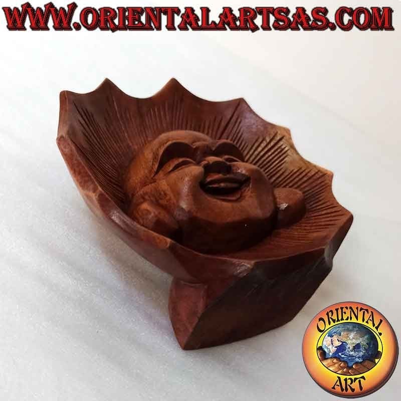 Face sculpture of the buddha of abundance carved out of suar wood