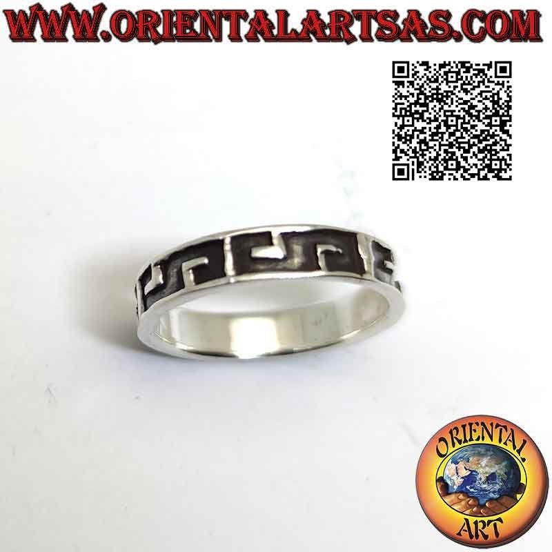 Silver band ring worked with a series of horizontal block letters with deep engraving