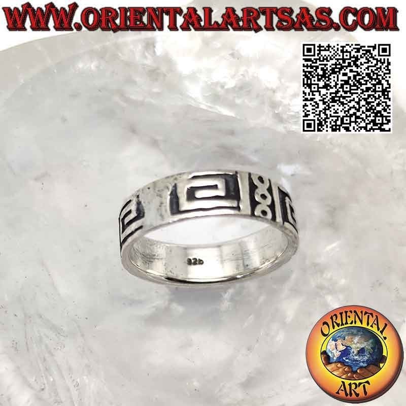 Silver band ring worked with a series of smooth squared spirals and circles on a smooth background