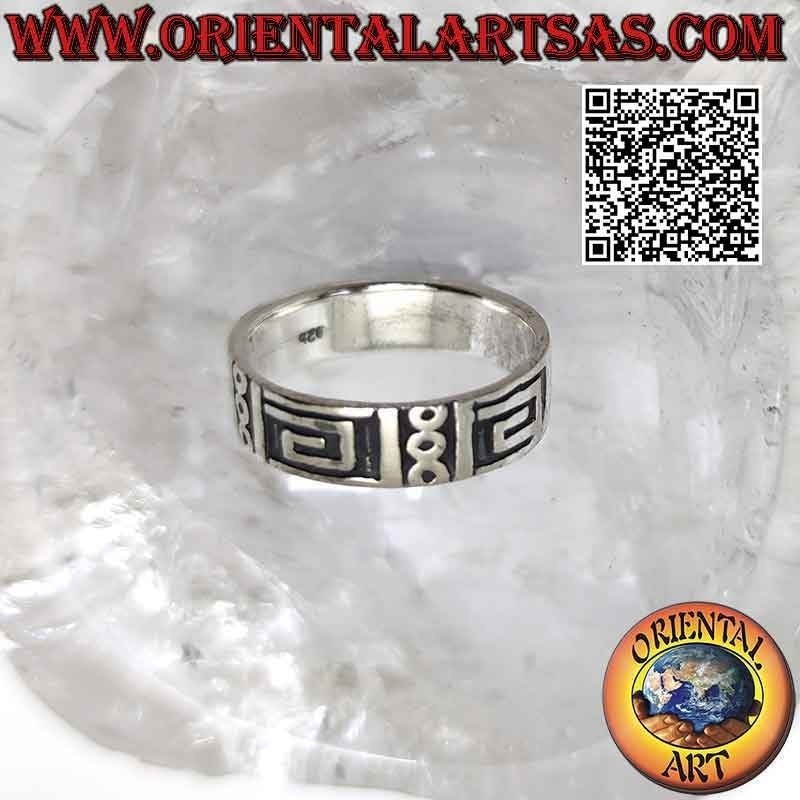 Silver band ring worked with a series of smooth squared spirals and circles on a smooth background