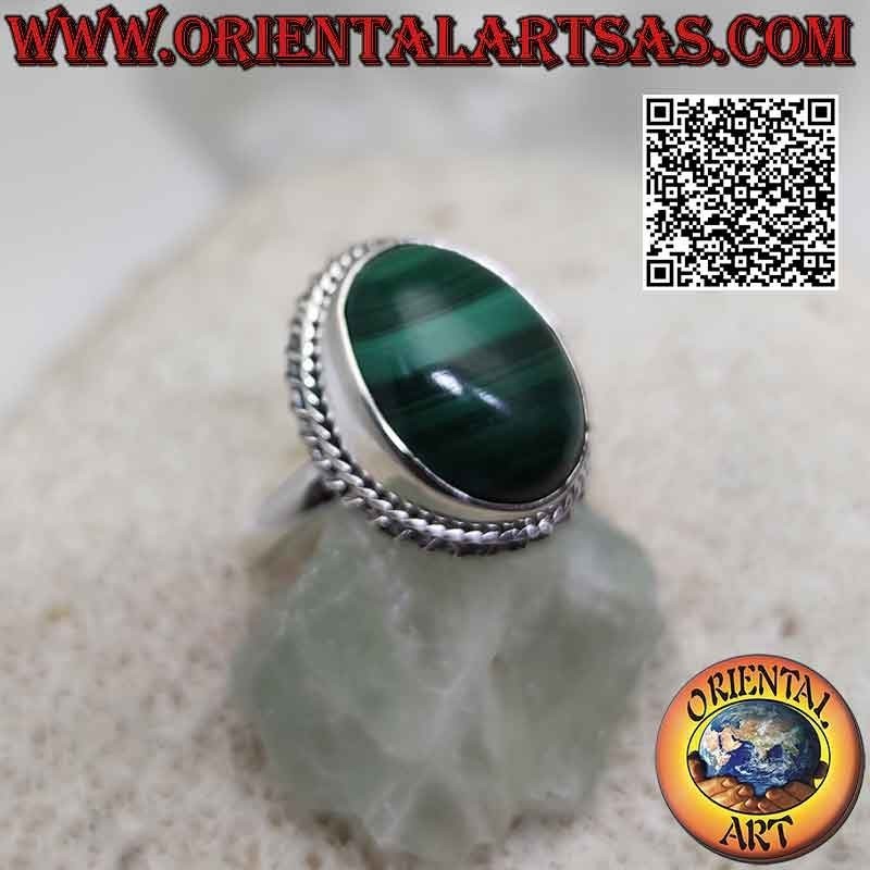 Silver ring with cabochon oval malachite (horizontal streaks) surrounded by interweaving and helical line