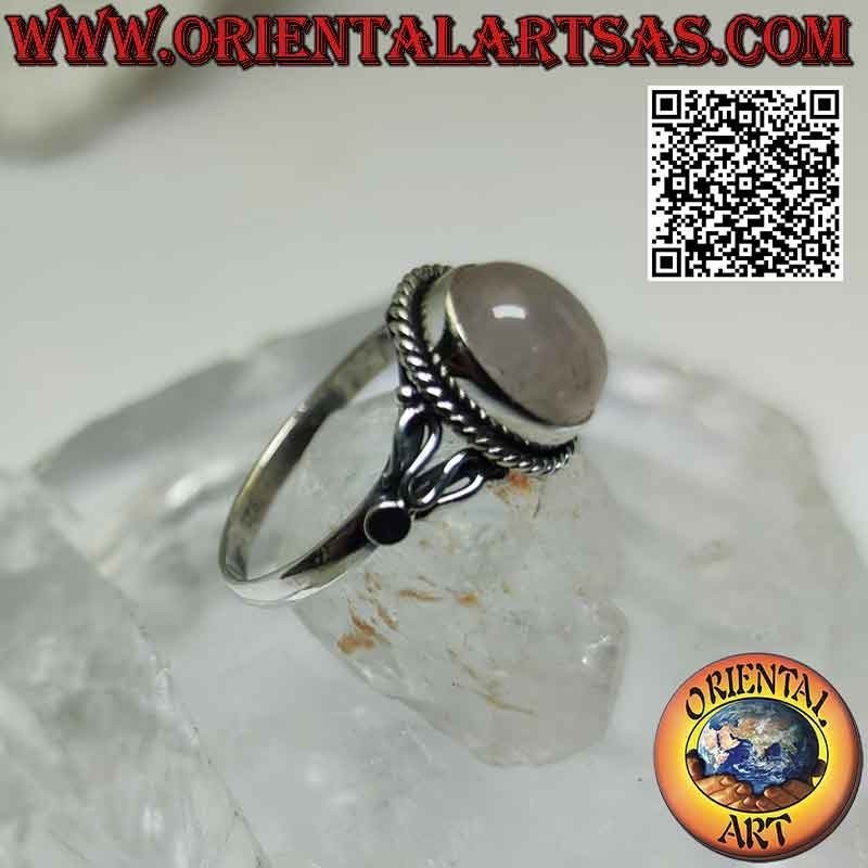 Silver ring with cabochon oval rose quartz surrounded by interweaving and serpentine on the sides
