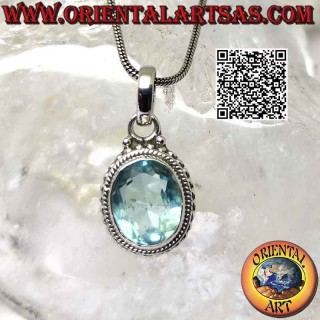 Silver pendant with faceted oval blue topaz surrounded by intertwining and balls