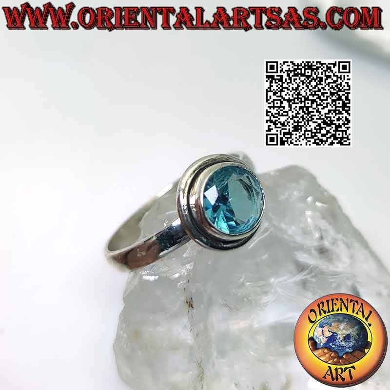 Silver ring with raised faceted round topaz and edge