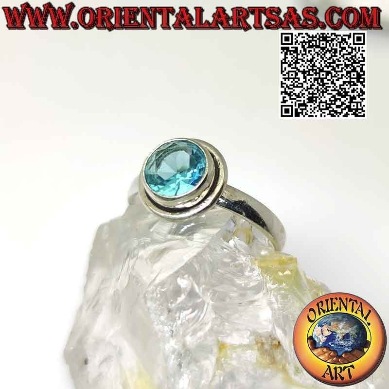 Silver ring with raised faceted round topaz and edge