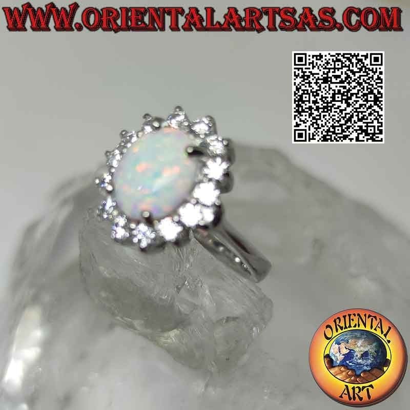 Silver ring with oval cabochon harlequin opal set surrounded by white zircons