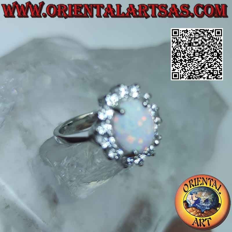 Silver ring with oval harlequin opal surrounded by zircons