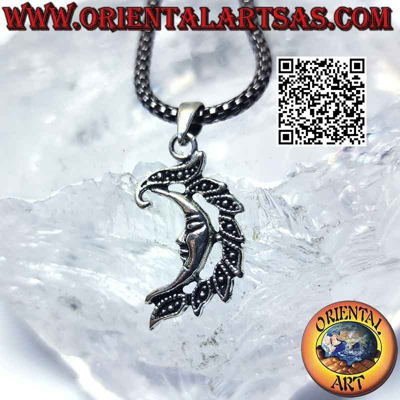 Silver pendant, smooth crescent with face and crest of leaves
