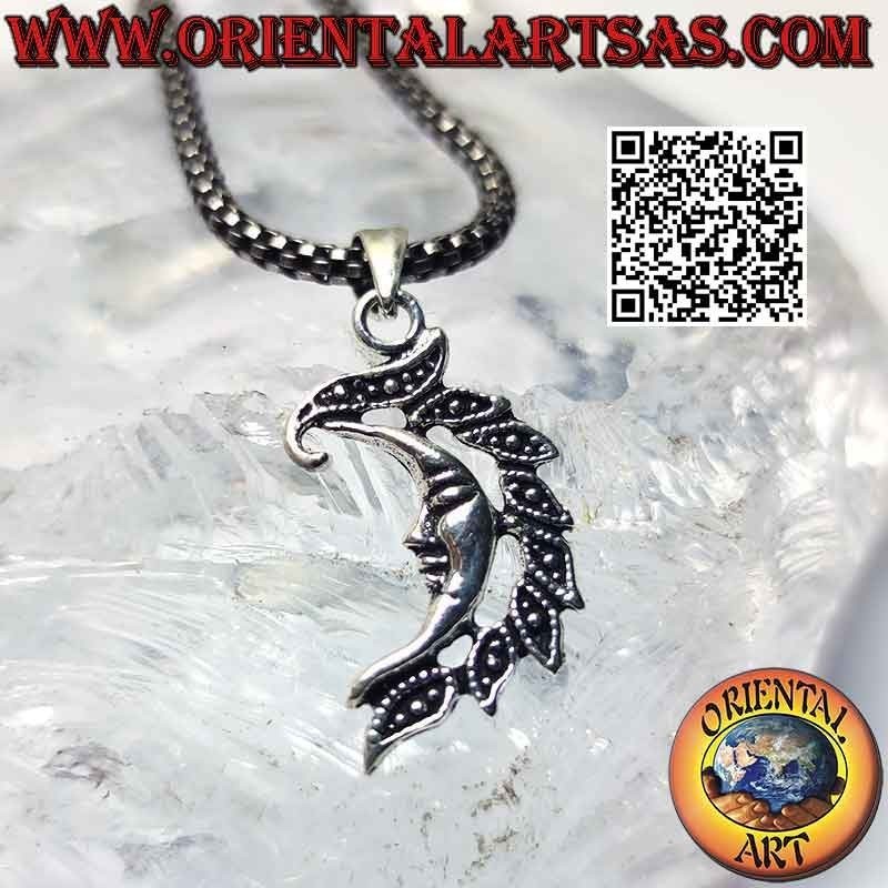 Silver pendant, smooth crescent with face and crest of leaves