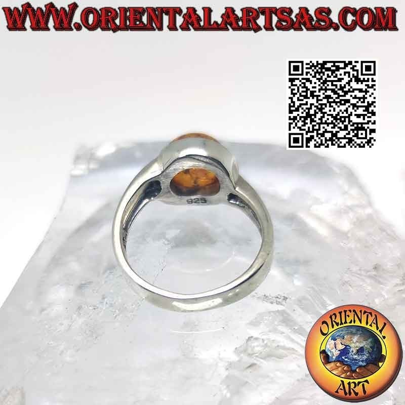 Anillo de plata con ámbar cabujón redondo y doble gancho asimétrico