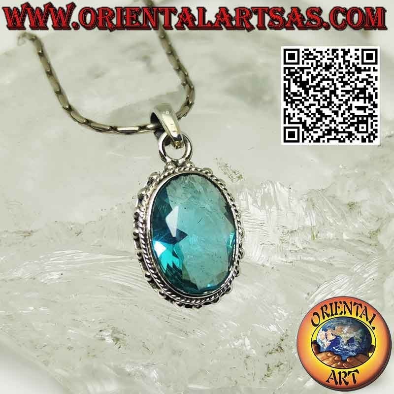 Silver pendant with faceted oval blue topaz surrounded by balls