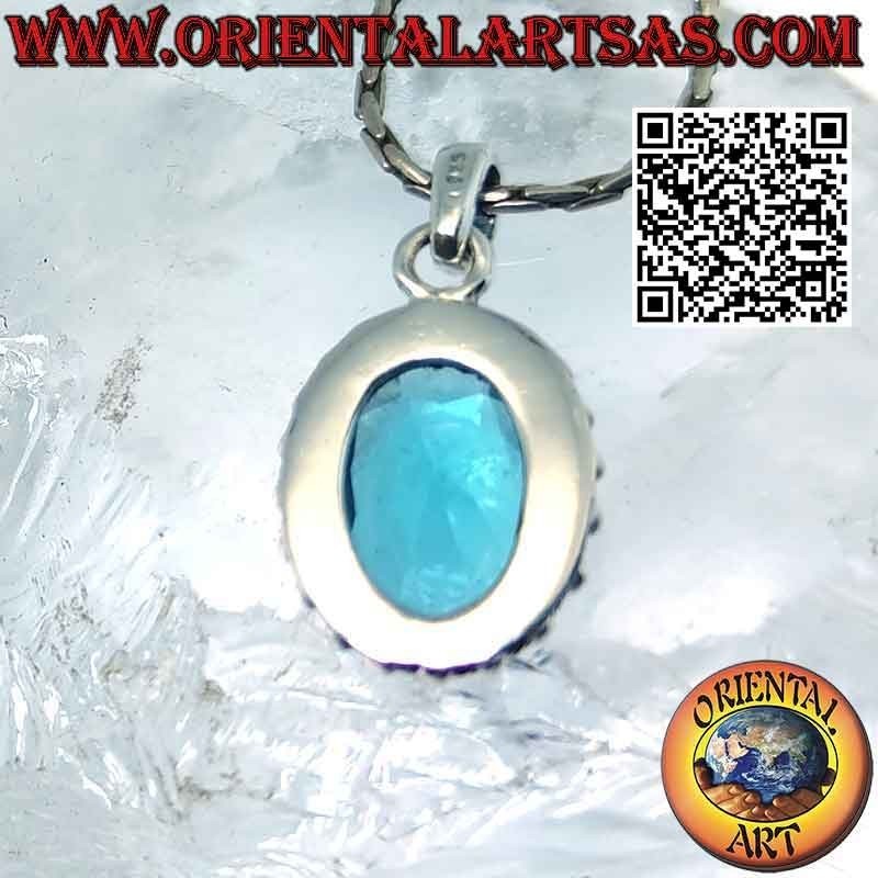 Silver pendant with faceted oval blue topaz surrounded by balls