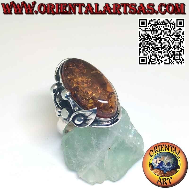 Silver ring with large oval amber and lily flower on one side