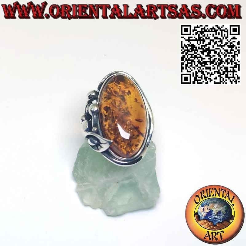 Silver ring with large oval amber and lily flower on one side