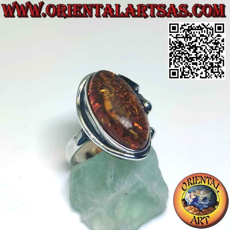 Silver ring with large oval amber and lily flower on one side