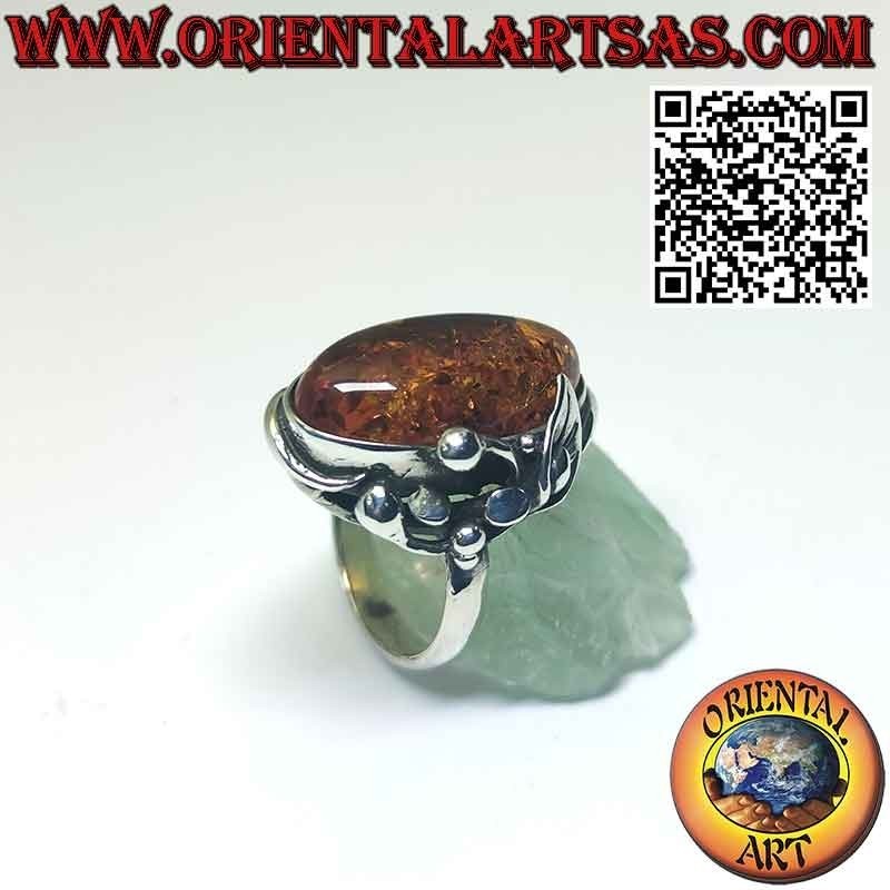 Silver ring with large oval amber and lily flower on one side