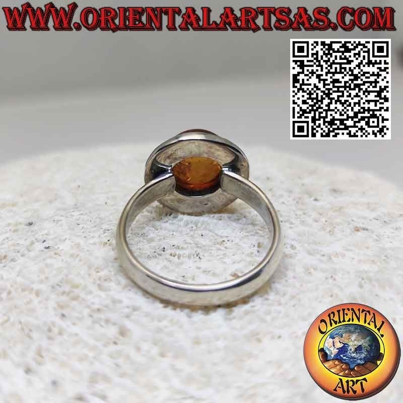 Silver ring with round hemispherical Baltic amber and solar edge