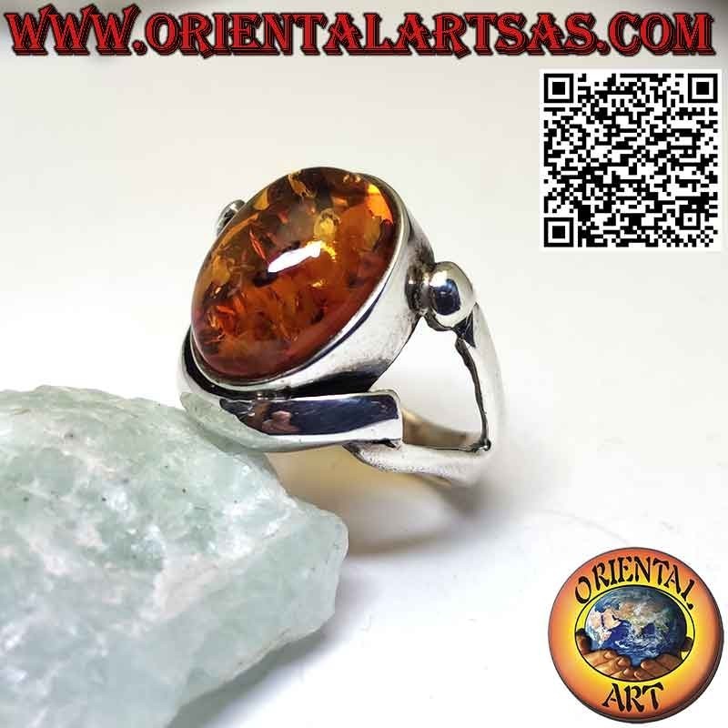 Silver ring with oval Baltic amber in a wraparound setting