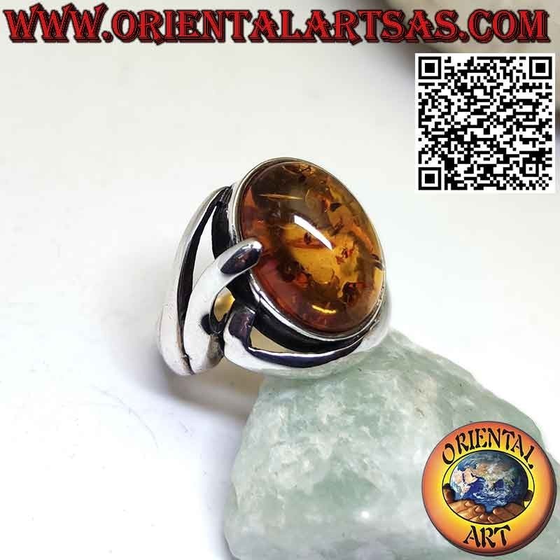 Silver ring with oval Baltic amber in a wraparound setting