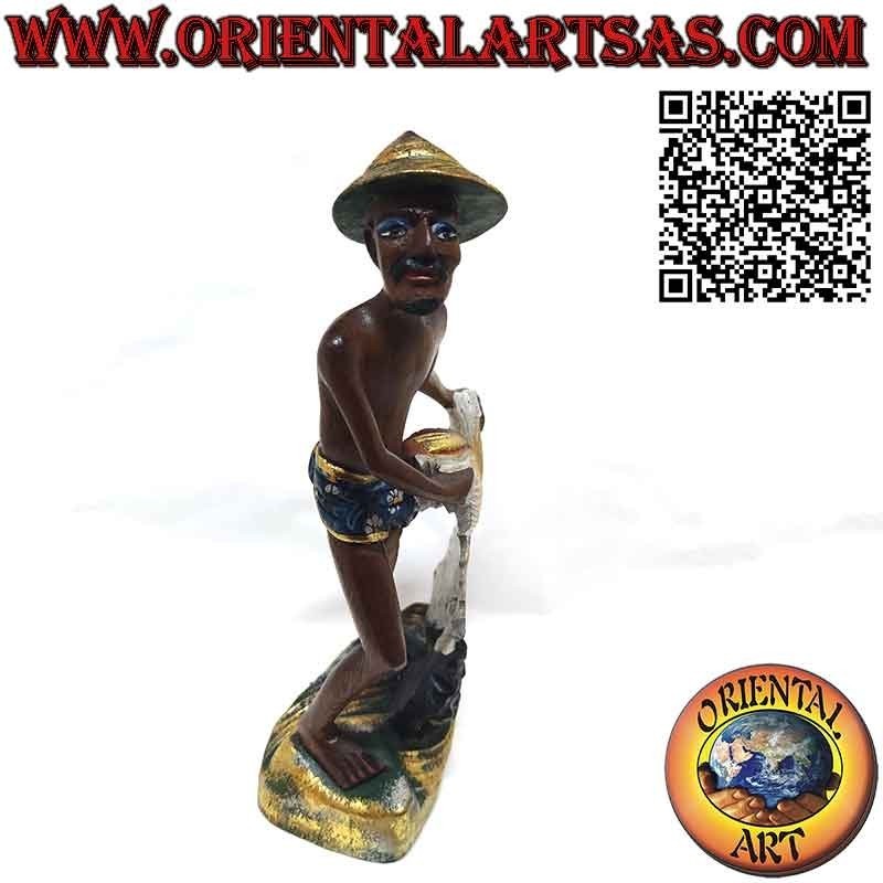 Beautiful and refined wooden sculpture of a fisherman with a net