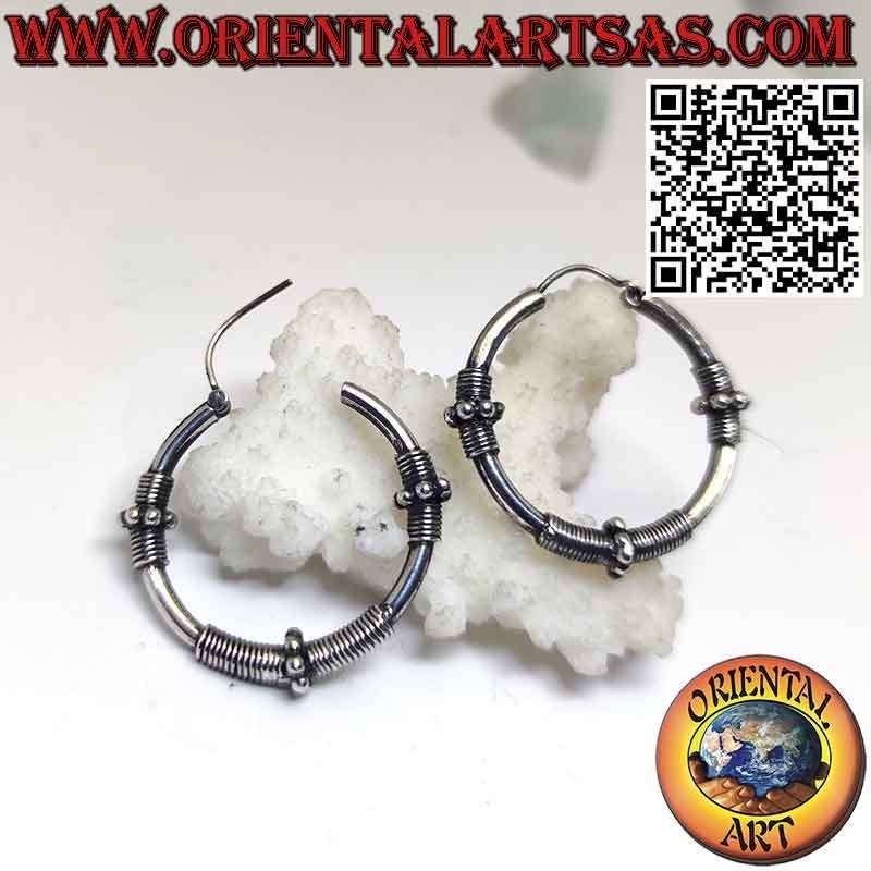 Earrings in silver circle with three sections of coiled wire and spheres