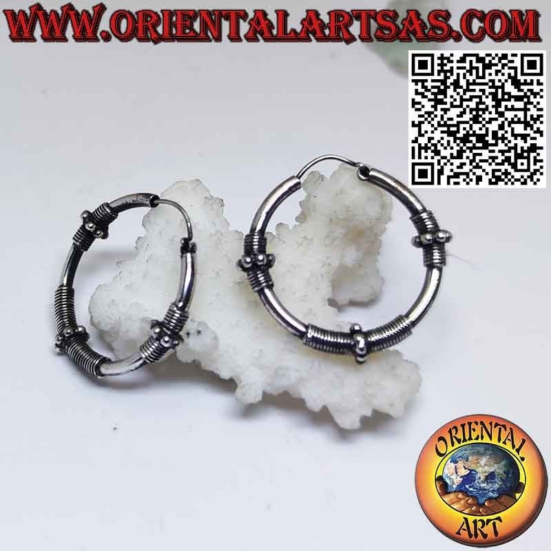 Earrings in silver circle with three sections of coiled wire and spheres