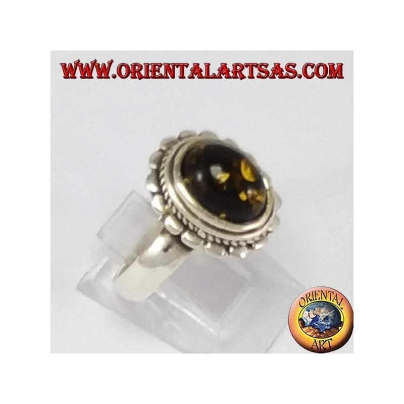 Silver ring with oval green amber