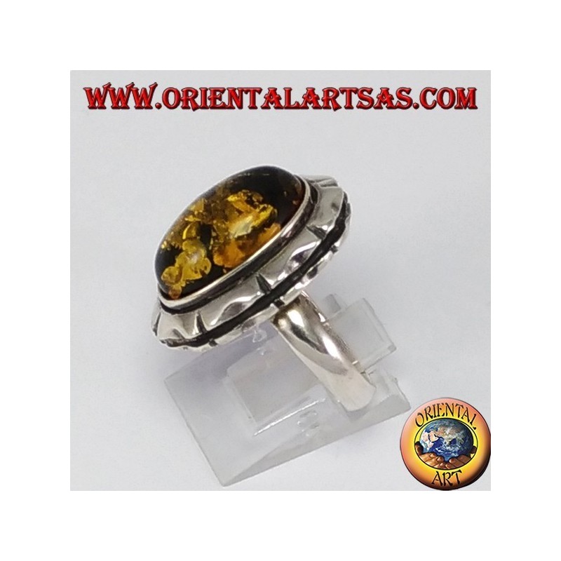 Silver ring with large green oval amber
