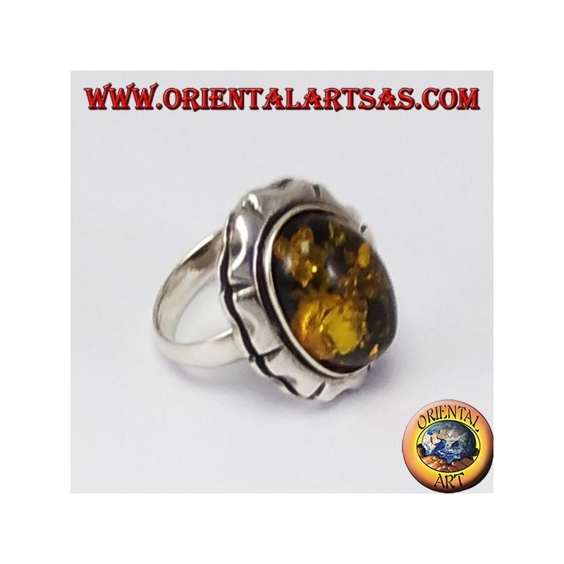Silver ring with large green oval amber