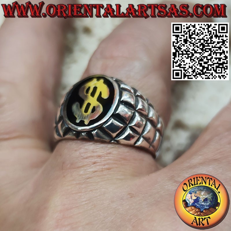 Silver ring with dollar symbol on a black and squared background