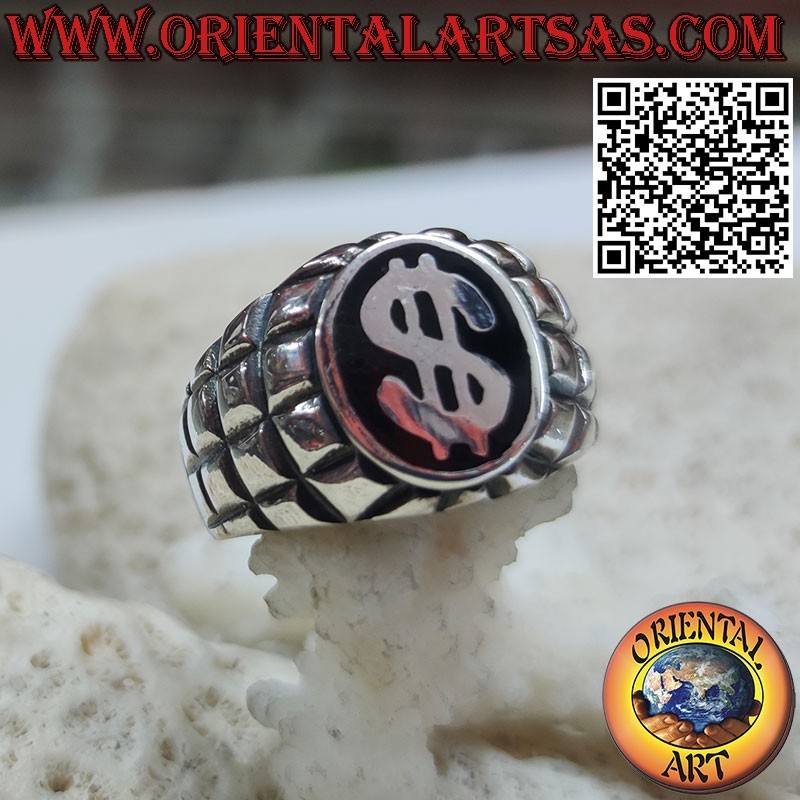 Silver ring with dollar symbol on a black and squared background