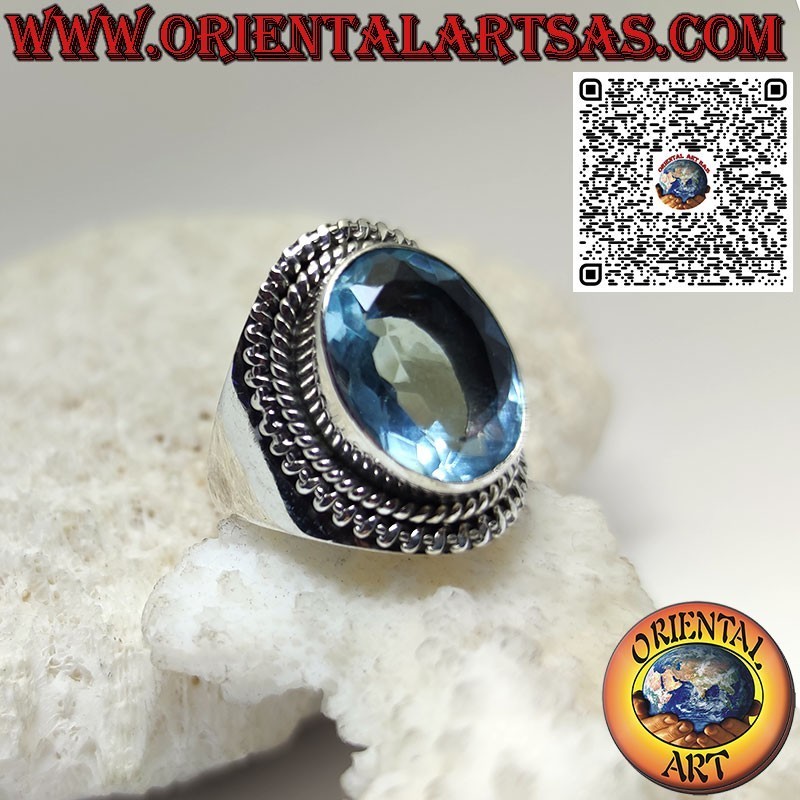 Silver ring with large oval blue topaz in a wide setting
