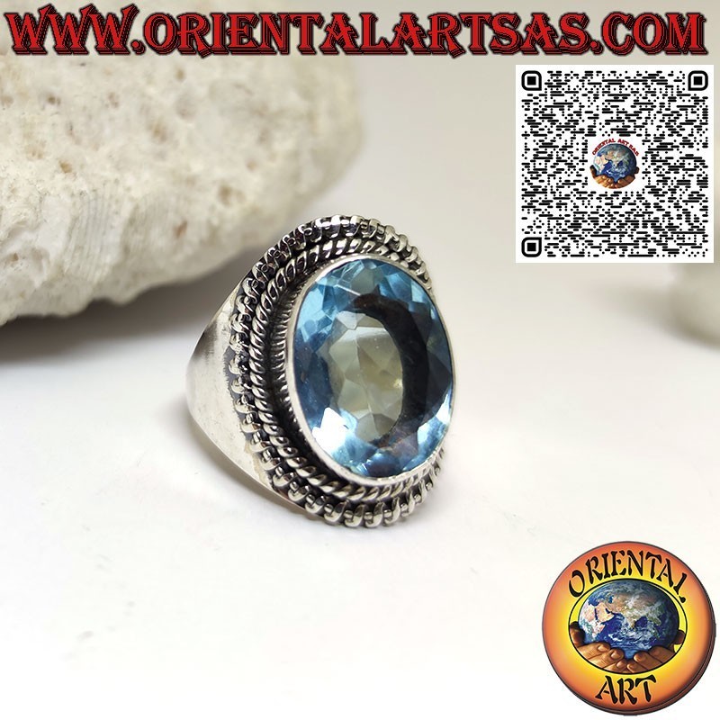 Silver ring with large oval blue topaz in a wide setting