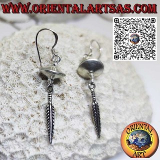 Silver earrings in the shape of a flying saucer spinning top with hanging feather