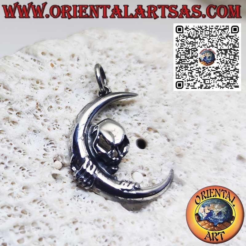 Silver pendant skull of darkness clinging to the moon