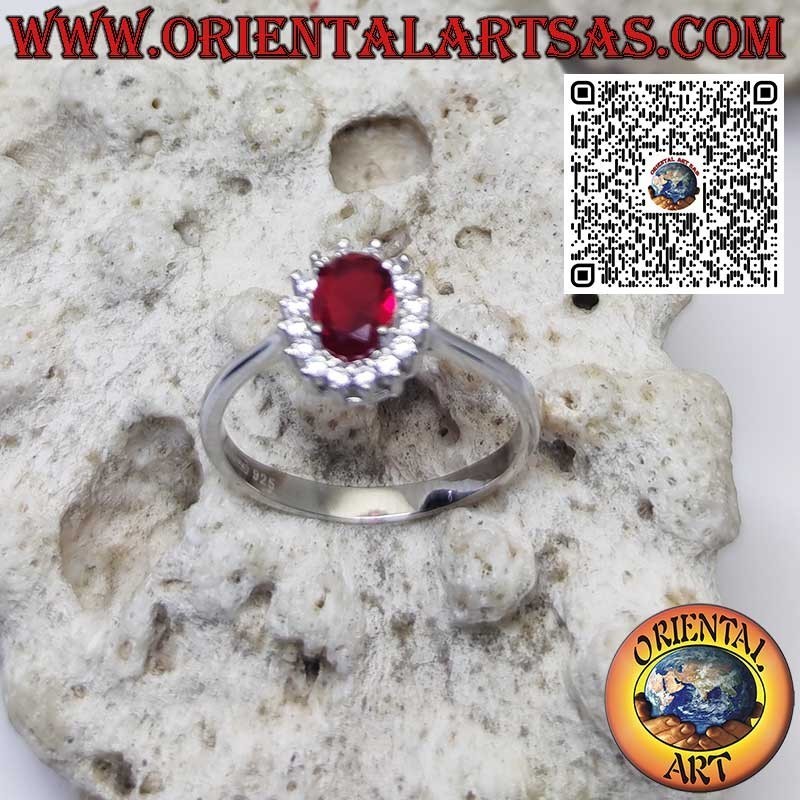 Silver ring with oval garnet set surrounded by zircons