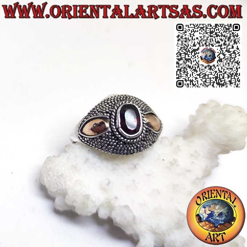 Silver ring with oval garnet and 14-karat gold plates on the sides