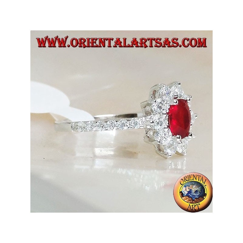 Silver ring with small oval garnet set surrounded by cubic zirconia and row on the sides