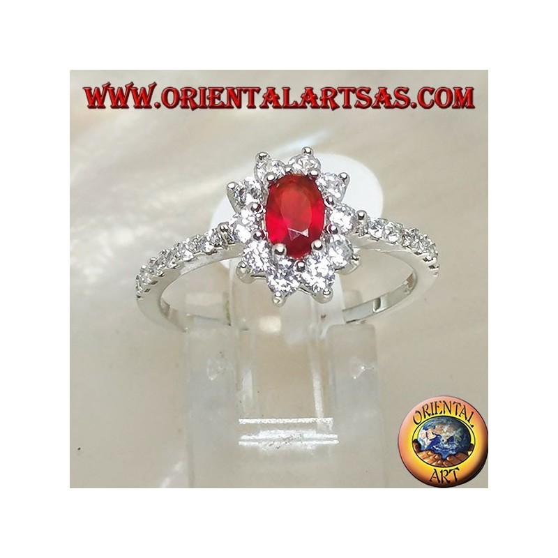 Silver ring with small oval garnet set surrounded by cubic zirconia and row on the sides