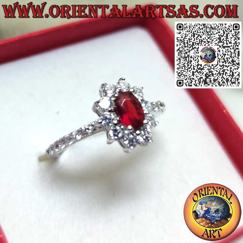 Silver ring with small oval garnet set surrounded by cubic zirconia and row on the sides