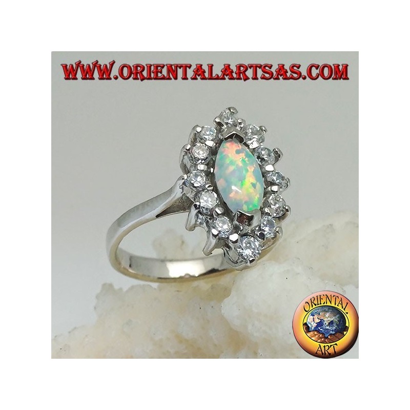 Silver ring with shuttle harlequin opal set on the tips surrounded by zircons