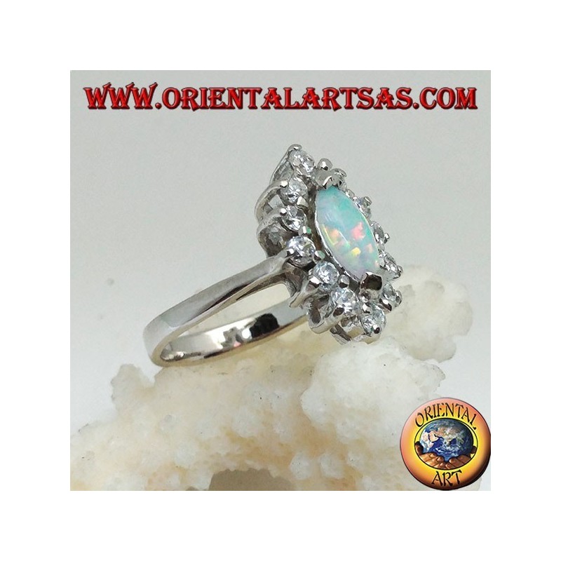 Silver ring with shuttle harlequin opal set on the tips surrounded by zircons