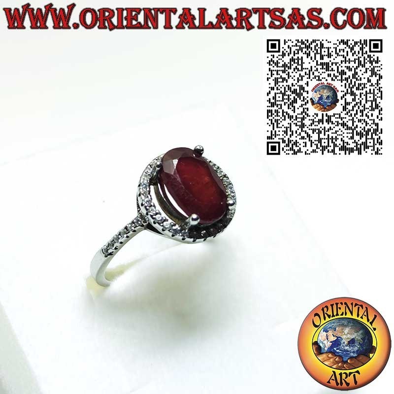 Anillo de plata con granate natural suspendido sobre un círculo de circonitas