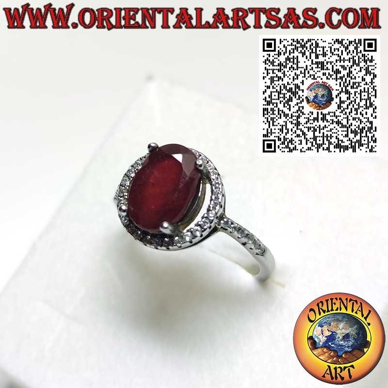 Silver ring with a natural garnet suspended on a circle of zircons