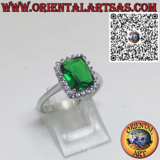 Silver ring with rectangular emerald surrounded by zircons