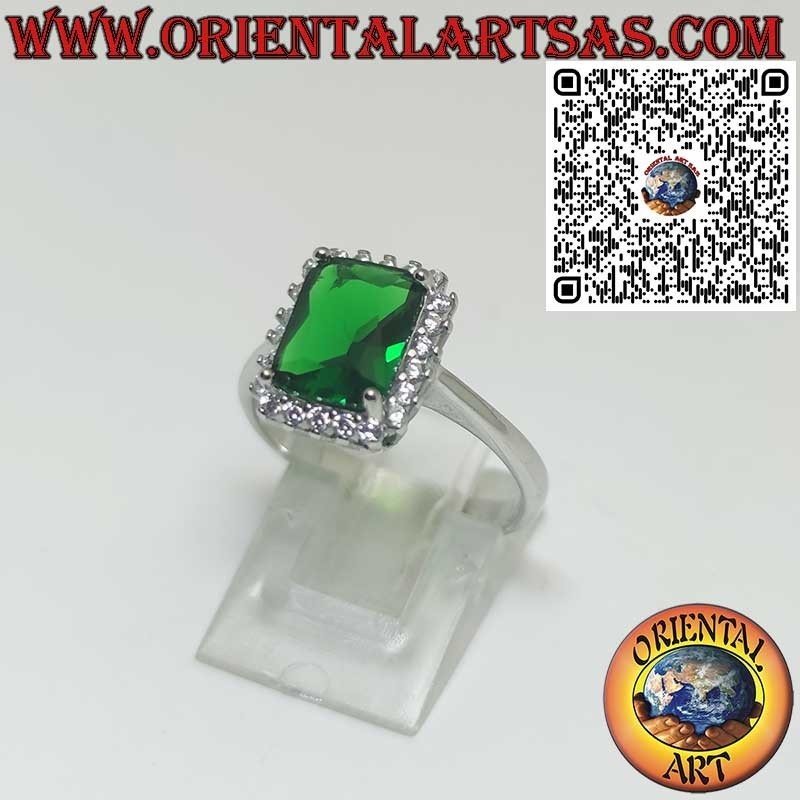 Silver ring with rectangular emerald surrounded by zircons