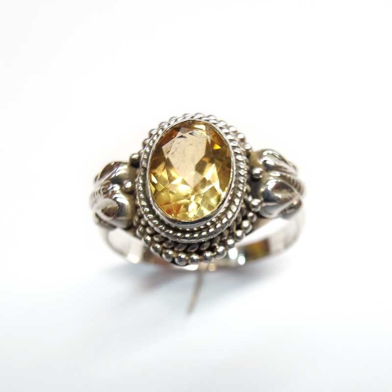 Silver ring with natural oval yellow topaz and side decorations